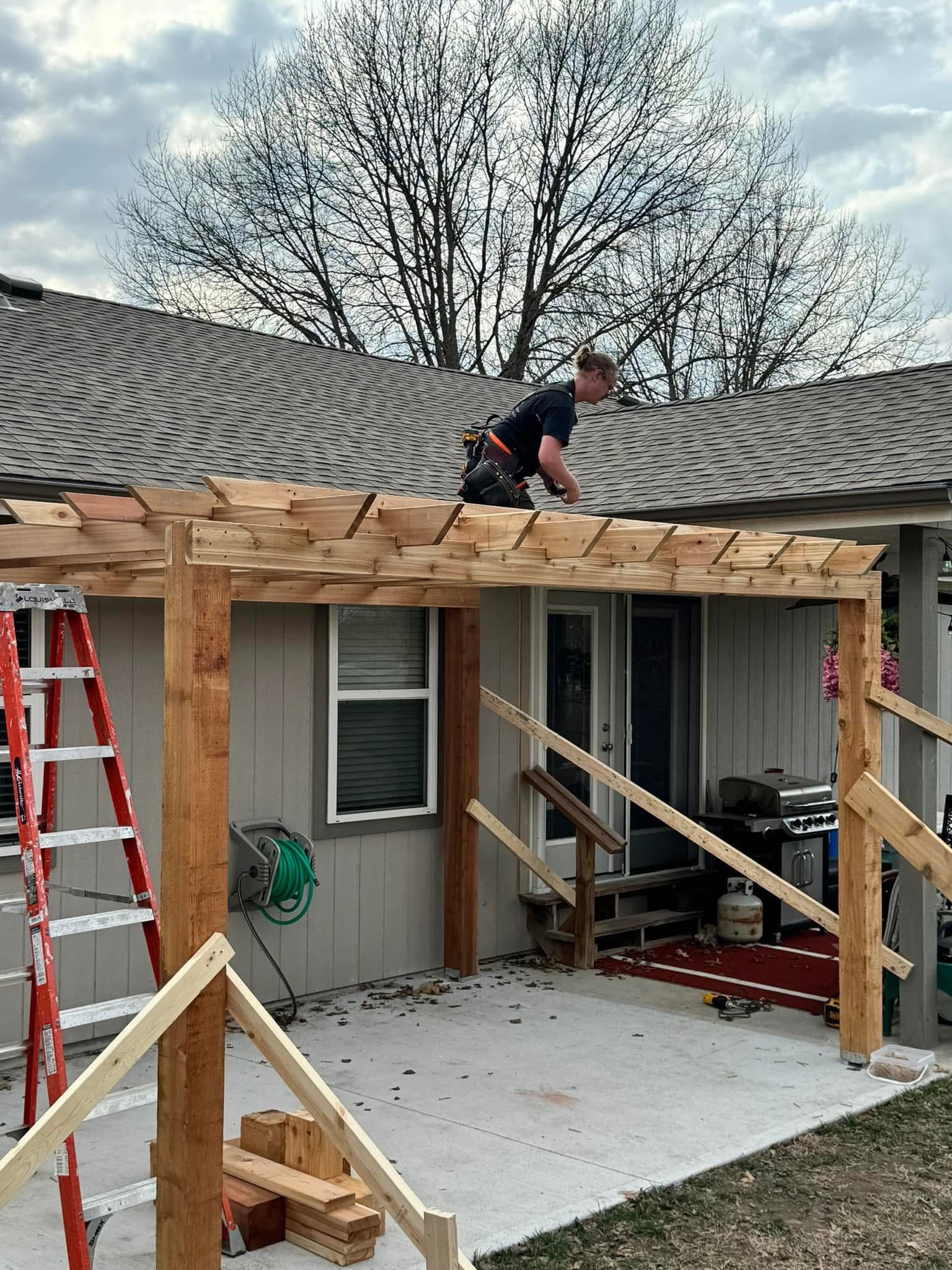 Pergola construction in progress over back patio