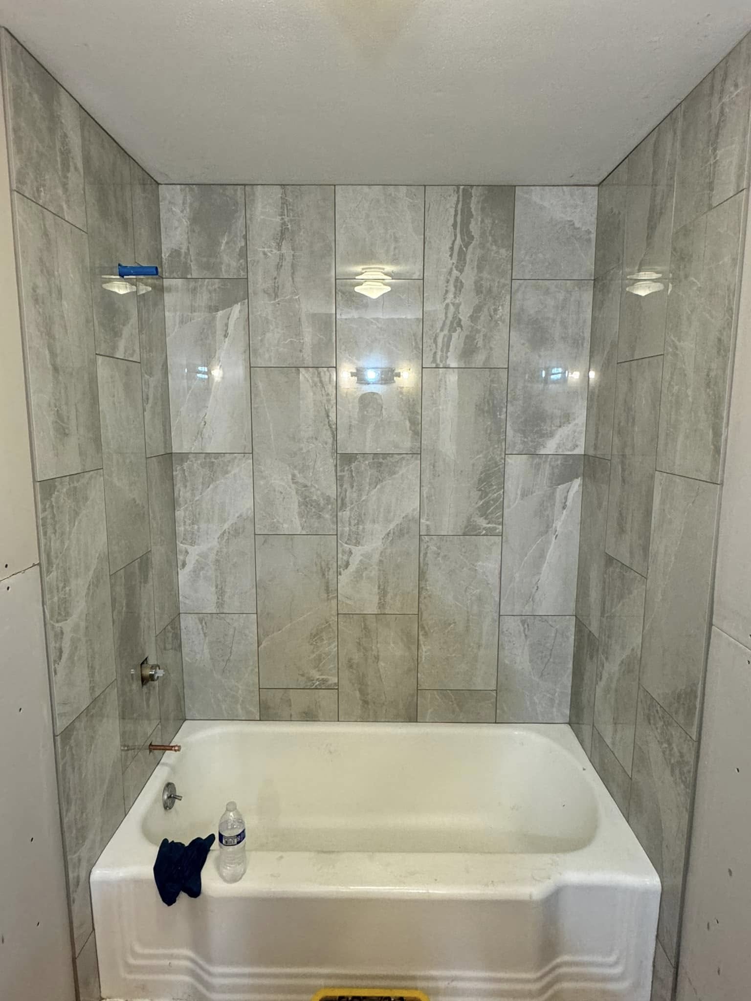 Expansive lakeside composite deck with wicker lounge furniture and panoramic views