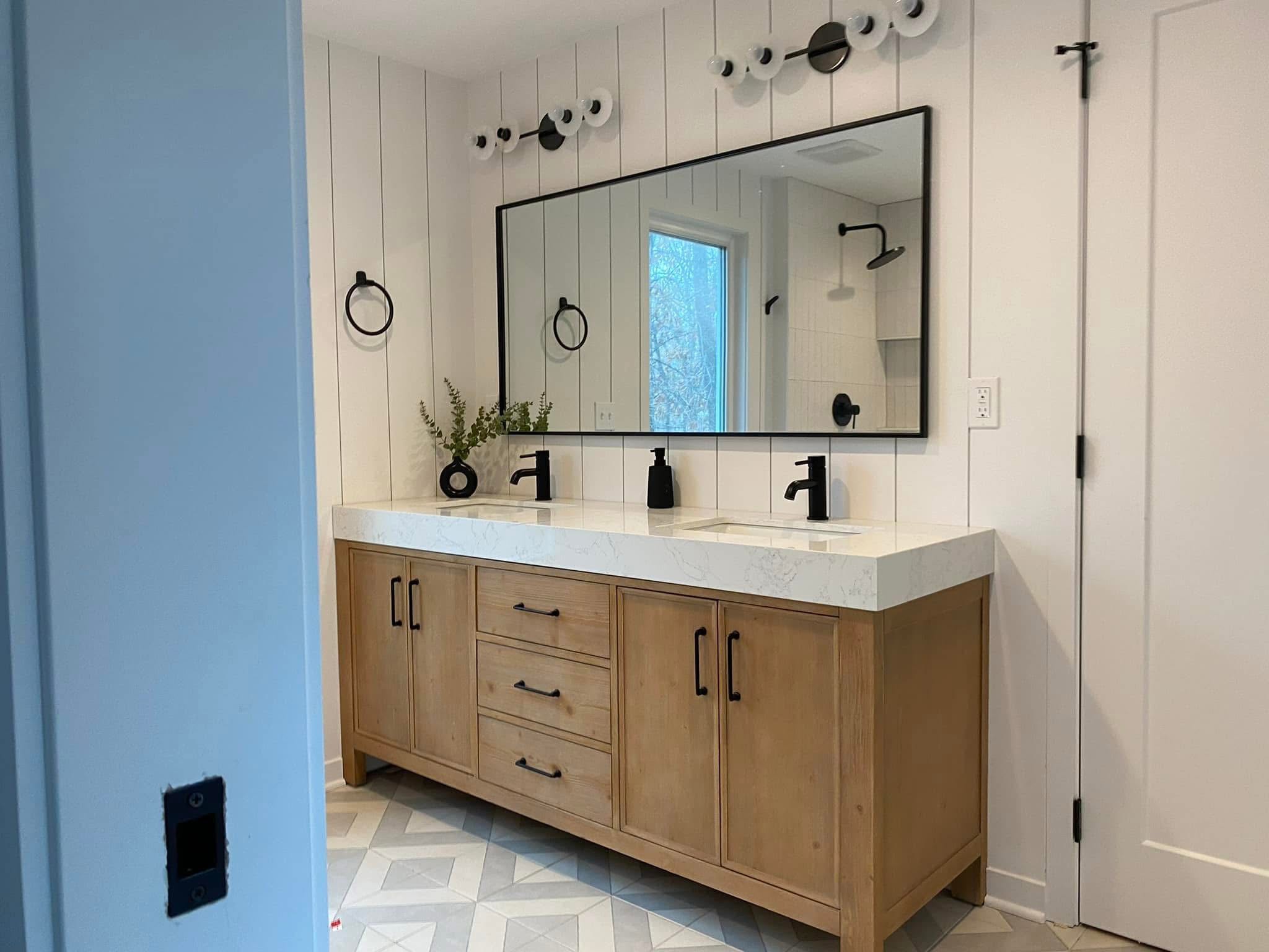 Double vanity bathroom with shiplap accent wall and matte black fixtures