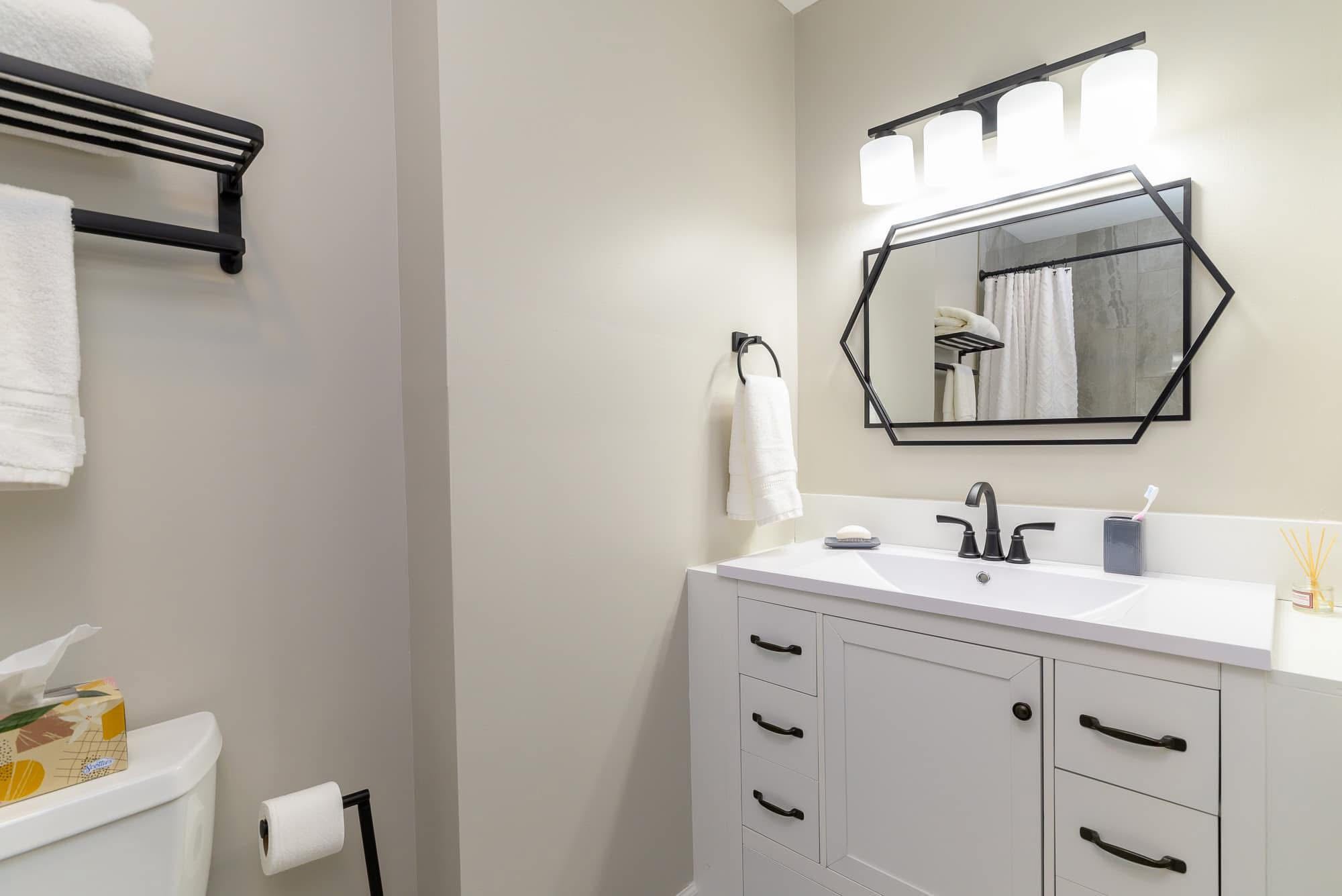 Elegant bathroom remodel with matte black fixtures and designer tile work