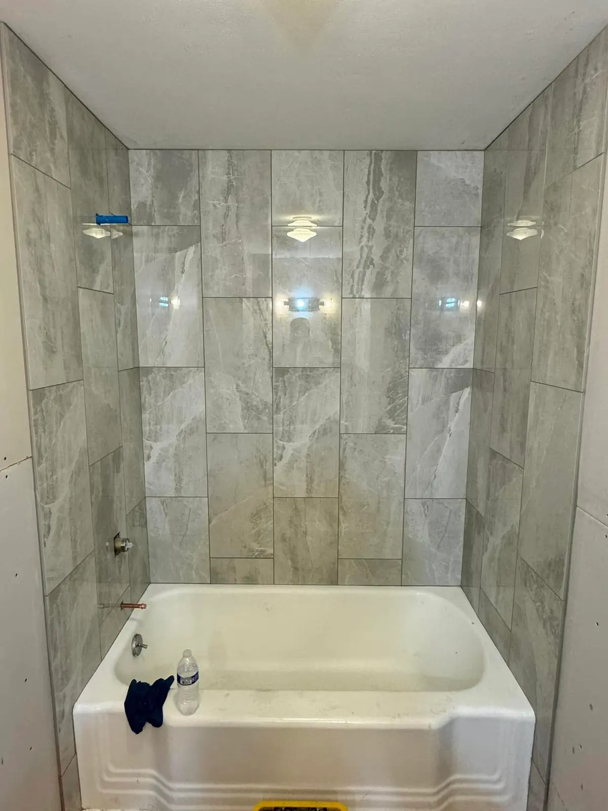 Bathroom remodel with gray vanity and large format tile walk-in shower