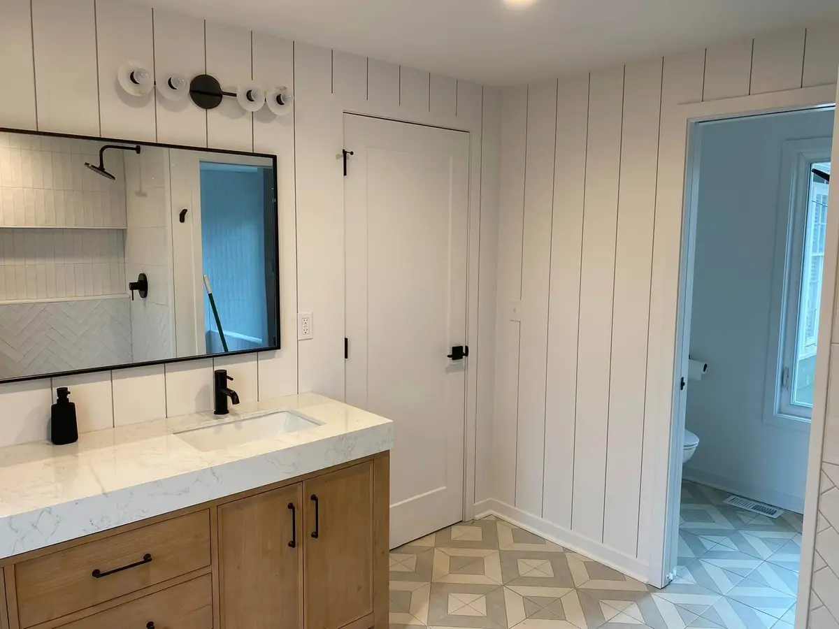 Modern farmhouse bathroom with shiplap walls and oak double vanity