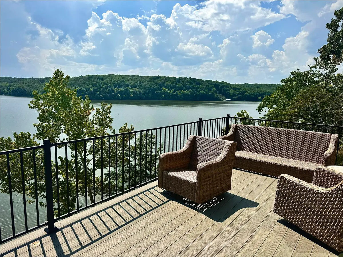 Lakeside composite deck with wicker outdoor seating overlooking the water
