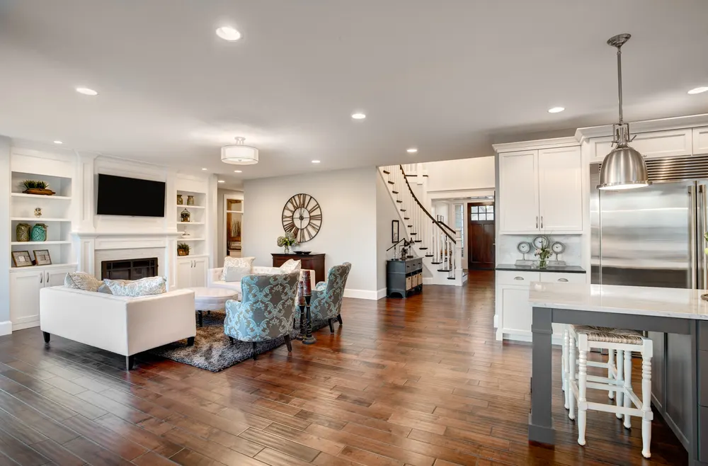 Hardwood-floored great room with a kitchen island, part of a JD Build whole-home remodel